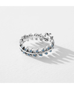 Macro detail of leaf-shaped silver ring with turquoise stones and textured engraving