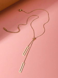 Detailed view of golden Y-shaped geometric necklace with adjustable slider bead chain