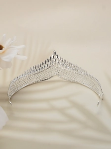 Detailed view of silver bridal crown with intricate hollow patterns and pointed design