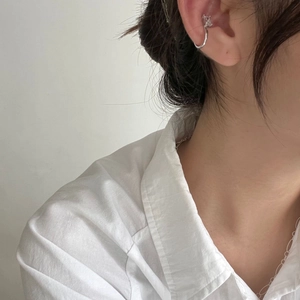 Detail of S925 sterling silver cuff earring with zircon on ear without piercing