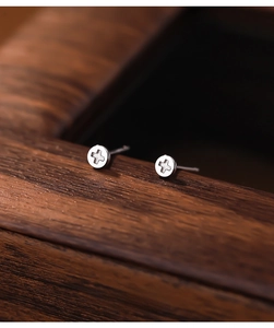 Detailed macro view of S925 sterling silver hoop earring featuring a relief cross design