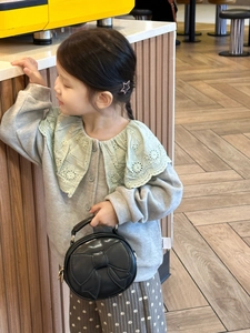 Kids mini round handbag with cute bow knot paired with a grey knit cardigan and lace collar