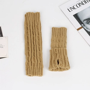 Detailed close-up of camel cable knit arm warmers with thumb holes and soft texture