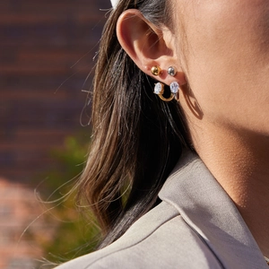 Chic 18K gold and silver stainless steel C-hoop earrings with white zircon on a model