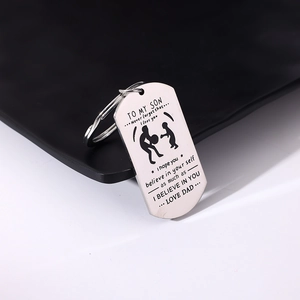 Detail of stainless steel dog tag keychain with To My Son laser engraved message and dad