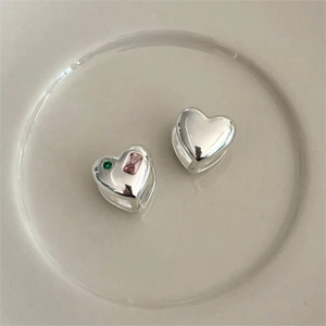 S925 sterling silver heart earrings with pink and green zircon stones on ceramic tray