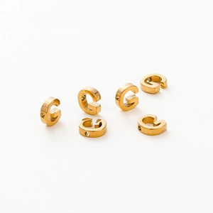 Detailed view of six gold-plated letter G charms with 1.8mm holes for DIY jewelry