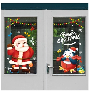 Detail showing Santa Claus and penguin window stickers on white glass door panels