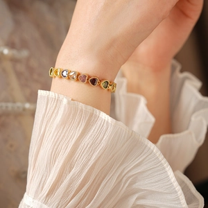 Detailed view of 18K gold plated bracelet featuring colorful heart-shaped gemstones