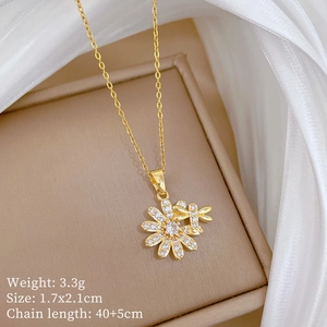 Detail of gold flower and dragonfly necklace set on soft jewelry box with measurements