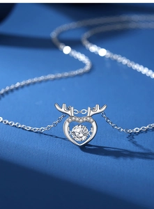 Detail of S925 silver deer antler heart necklace with a sparkling dancing moissanite