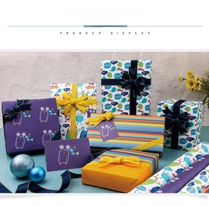 Detail showing cartoon monster gift wrapping paper with colorful ribbons and cards