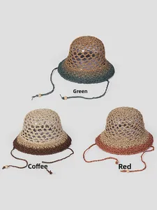 Detailed view of handmade hollow straw hats in green, coffee, and red with wooden beads