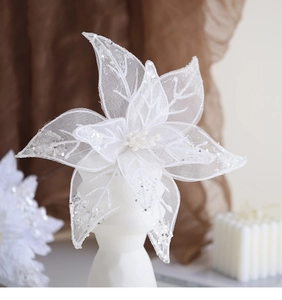 Close-up of white sheer mesh artificial flower with silver glitter for Christmas decor