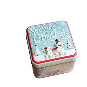 Square Christmas snowman tin gift box with Seasons Greetings text on a blue lid