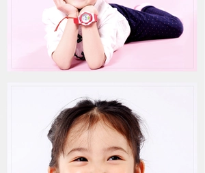 Close-up of a child wearing a waterproof digital watch with red strap and white bezel