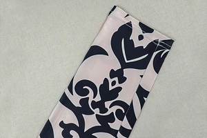 Close-up of elegant black and beige damascus print fabric with precision stitching detail