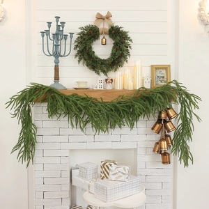 Christmas pine needle wreath and garland with pinecones and bells for fireplace decor