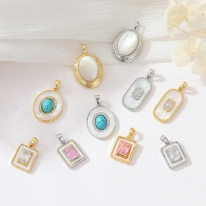 Detailed view of luxury gold and silver pendants with shell and gemstone inlays