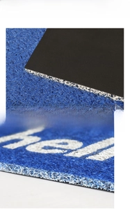 Detail of blue and white PVC coil door mat showing non-slip backing and surface texture