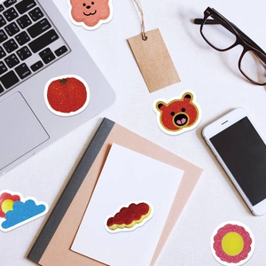Flat lay of pink Y2K aesthetic glitter stickers with cute cartoon bears and cloud designs