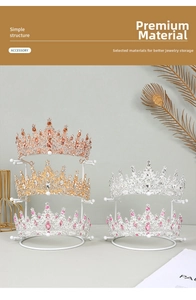 Golden metal jewelry display stands showcasing diverse crystal tiaras and bridal crowns