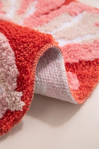 Macro shot of plush 3D floral bath mat showing thick pile and non-slip backing texture