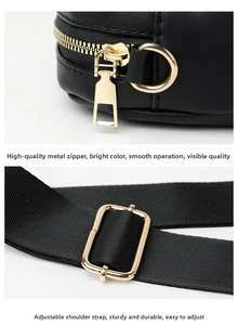 Detail of polished gold hardware zipper and adjustable strap on a black quilted bag