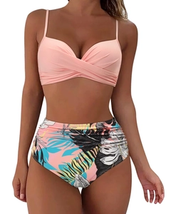 Detail of pink twist bikini top and high waisted tropical leaf print swim bottom