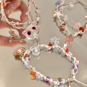 Detail of colorful woven starfish bracelets with natural stones and shell charms