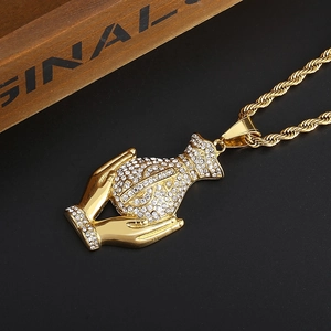 Detailed shot of iced out money bag pendant with dollar sign on gold twist chain