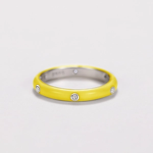 Detail of yellow enamel S925 sterling silver ring with sparkling zircon inlays