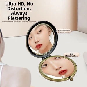 Detail of vintage folding mirror showing 2X magnification for precise makeup application