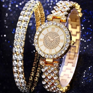 Close-up of luxury gold-tone watch set with crystals on shimmering blue background
