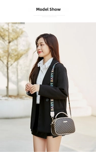 Detail of printed crossbody bag with embroidered colorful LOVE wide shoulder strap