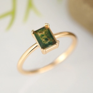 Elegant gold minimalist ring featuring a rectangular moss green stone with four-prong setting