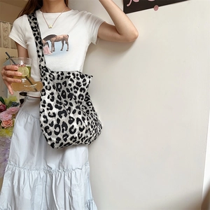 Fashionable leopard print canvas tote bag with large capacity worn as a crossbody bag