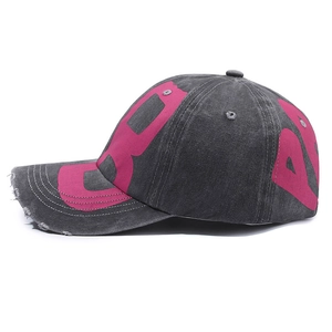 Vintage washed black baseball cap with bold pink lettering and distressed brim