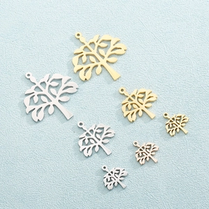 Rose gold tree of life pendants in three colors and sizes on blue textured background