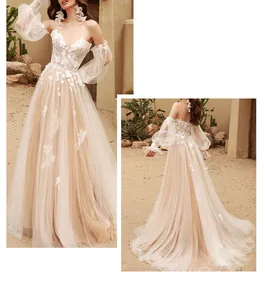 Detail of off-shoulder lace wedding dress with puff sleeves and floral appliqués