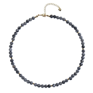 Detail of beaded necklace with gray marble beads, gold spacers, and heart charm extension