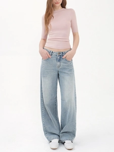 Slim fit pink t-shirt paired with light blue wide leg jeans on a white background