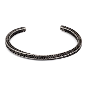 Detailed macro view of retro stainless steel cuff bracelet with scale-like hammered texture