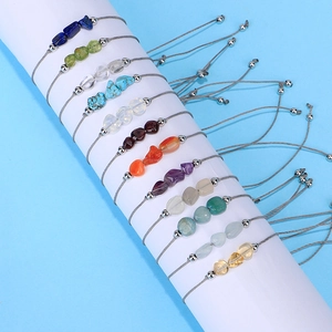 Handmade woven bracelet featuring natural irregular birthstones and metallic spacer beads