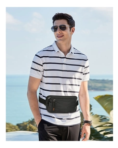 Detail of black waterproof running belt bag with multiple zipper pockets on male model