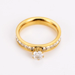 Detail of gold-plated stainless steel ring with six-prong setting and side diamonds