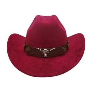 Detail of bull head metal ornament on pink felt cowboy hat with brown leather band