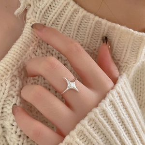 Minimalist 925 sterling silver four-point star open ring worn on a finger