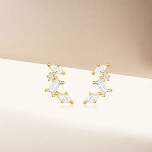 Macro shot of gold silver earrings with marquise-cut white zircons and reflection