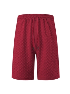 Close-up of red herringbone quilted fabric texture and drawstring on men's beach shorts